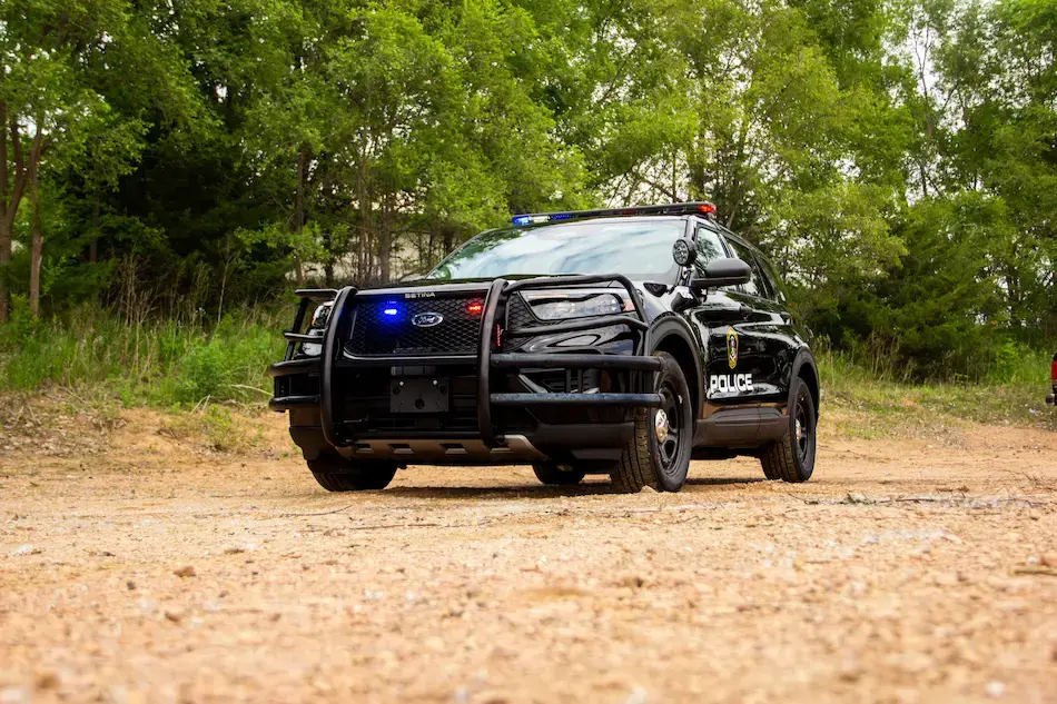 Police patrol vehicle undergoing professional upfitting with emergency lighting, communications, storage systems, and public safety equipment for law enforcement operations.